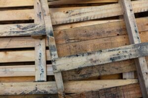 A pile of wooden pallets that are stacked together.