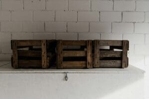 Three wooden crates sitting on top of a wall.